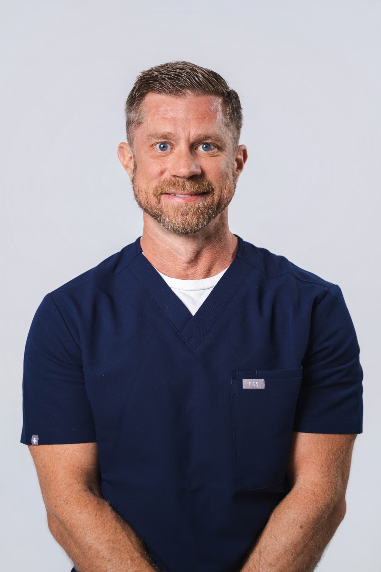 Dr. Chad Hobbs in navy medical scrubs